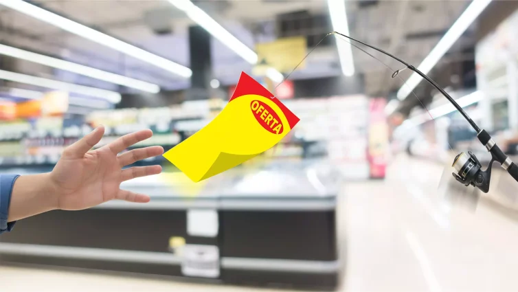 Mão tentando alcançar um cartaz amarelo e vermelho com a palavra “OFERTA” pendurado em uma vara de pescar, representando a dificuldade de manter as vendas após a Black Friday.